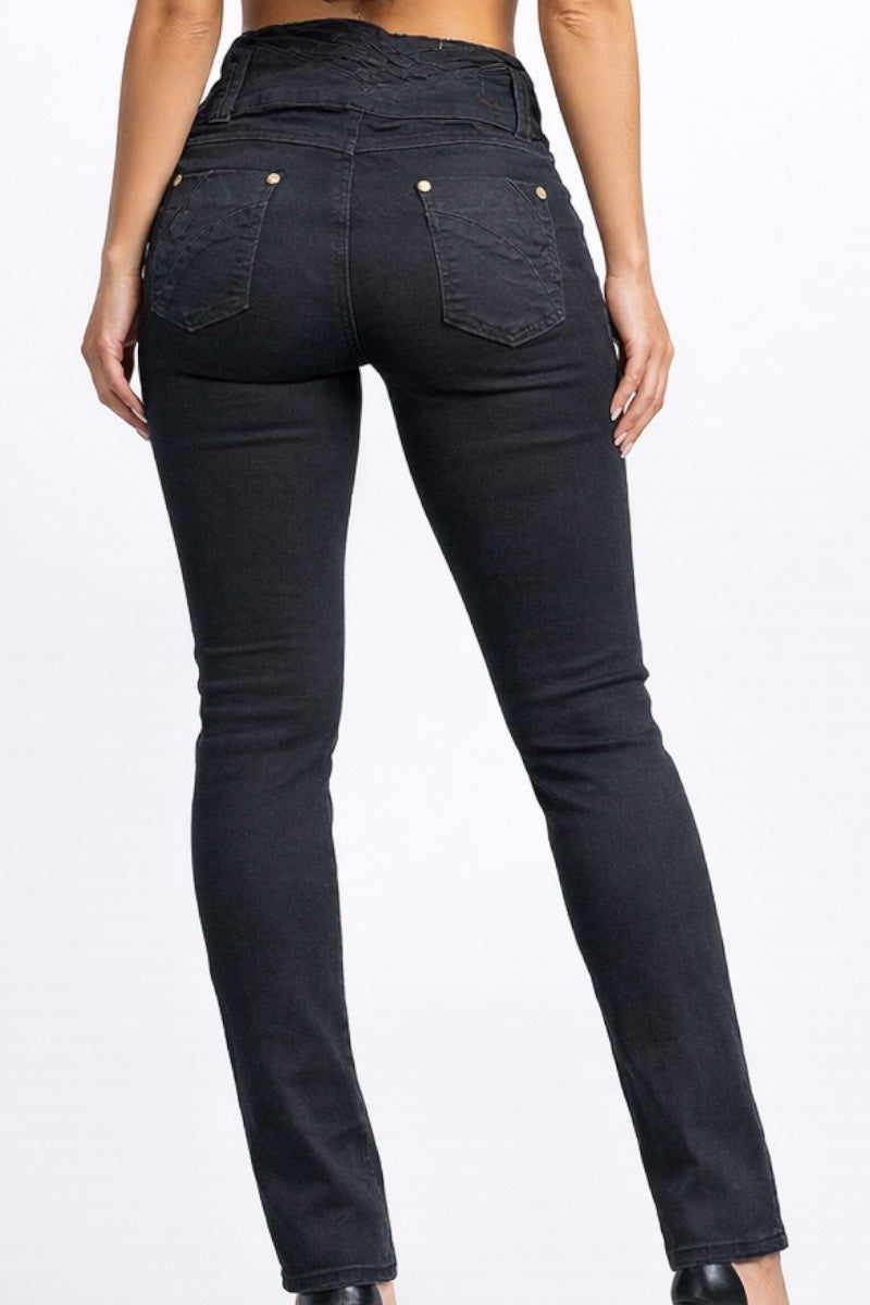 Black jeans worn by a person on a white background
