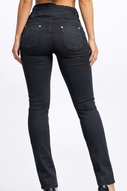Black jeans worn by a person on a white background