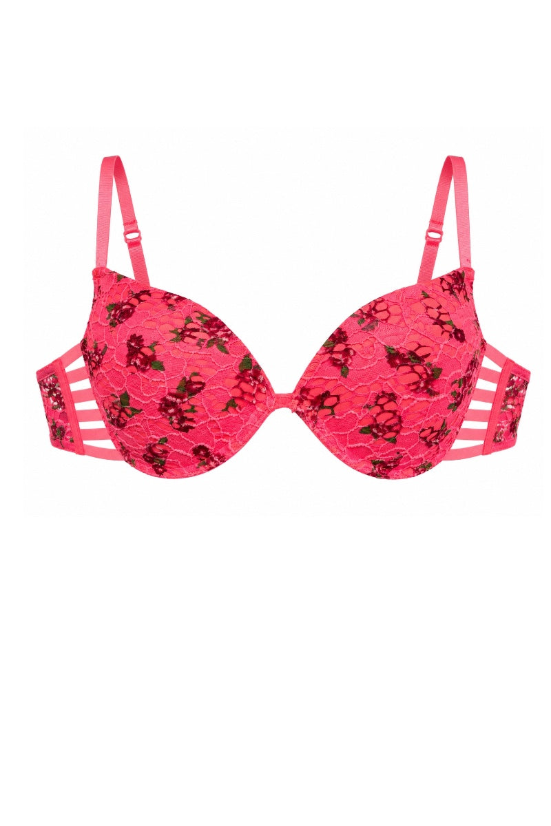 A bright pink lace bra with a black floral pattern and white side cutouts, shown against a plain white background.