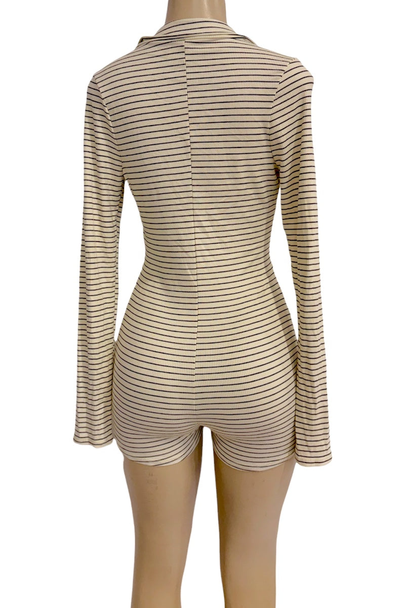 A cream and black horizontally striped long-sleeve romper displayed on a mannequin from the back view, set against a plain white background.