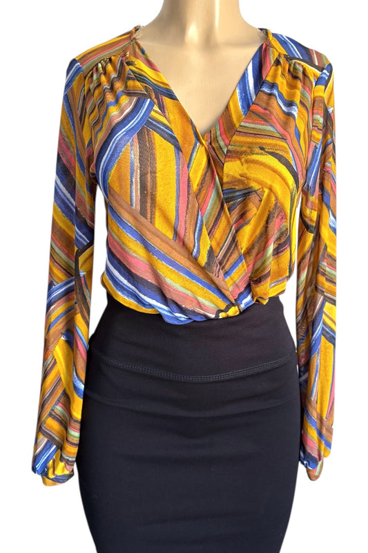 Colorful patterned blouse on a mannequin with a black skirt