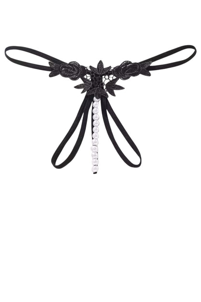 Black lace thong with floral details and a central bead on a white background