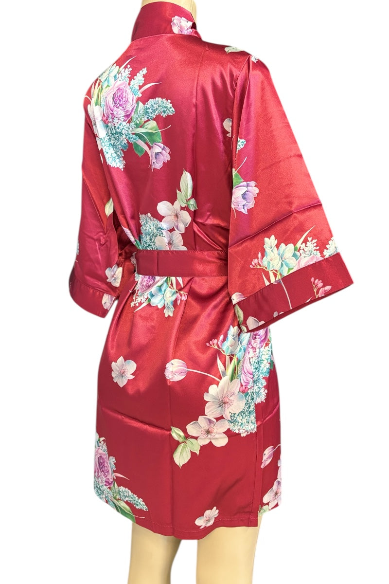 Red satin robe with floral patterns on a mannequin against a white background