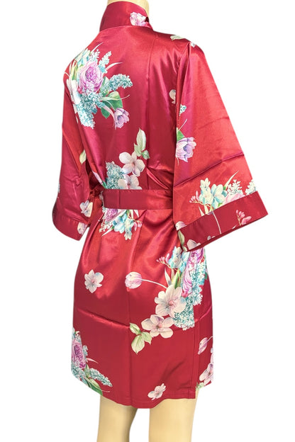 Red satin robe with floral patterns on a mannequin against a white background