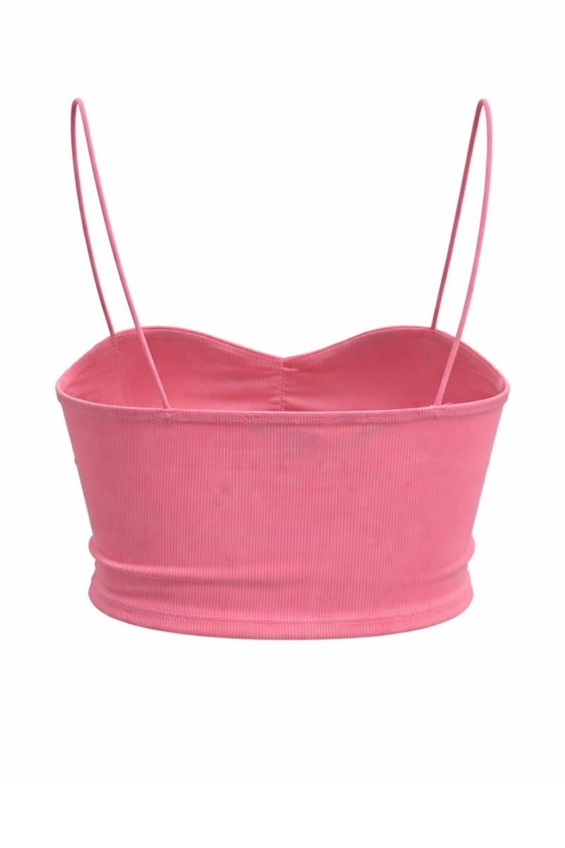 Pink crop top with thin straps on a white background