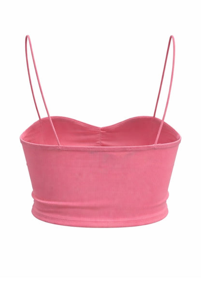 Pink crop top with thin straps on a white background