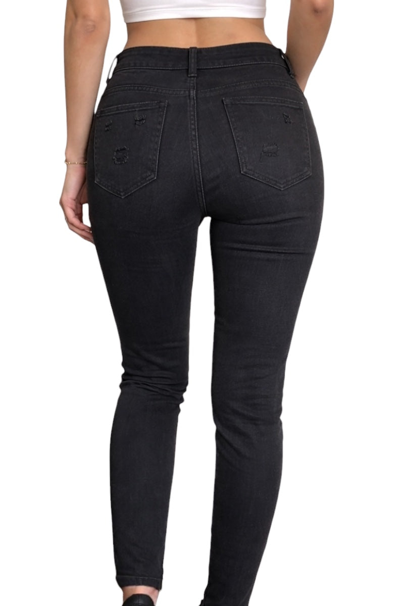 Black jeans worn by a person on a white background