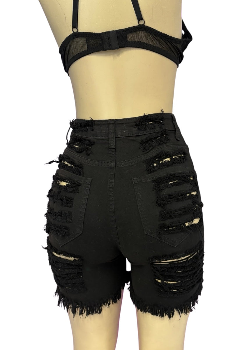 Black high-waisted distressed denim shorts with frayed hems and ripped details, displayed on a beige mannequin torso against a white background.