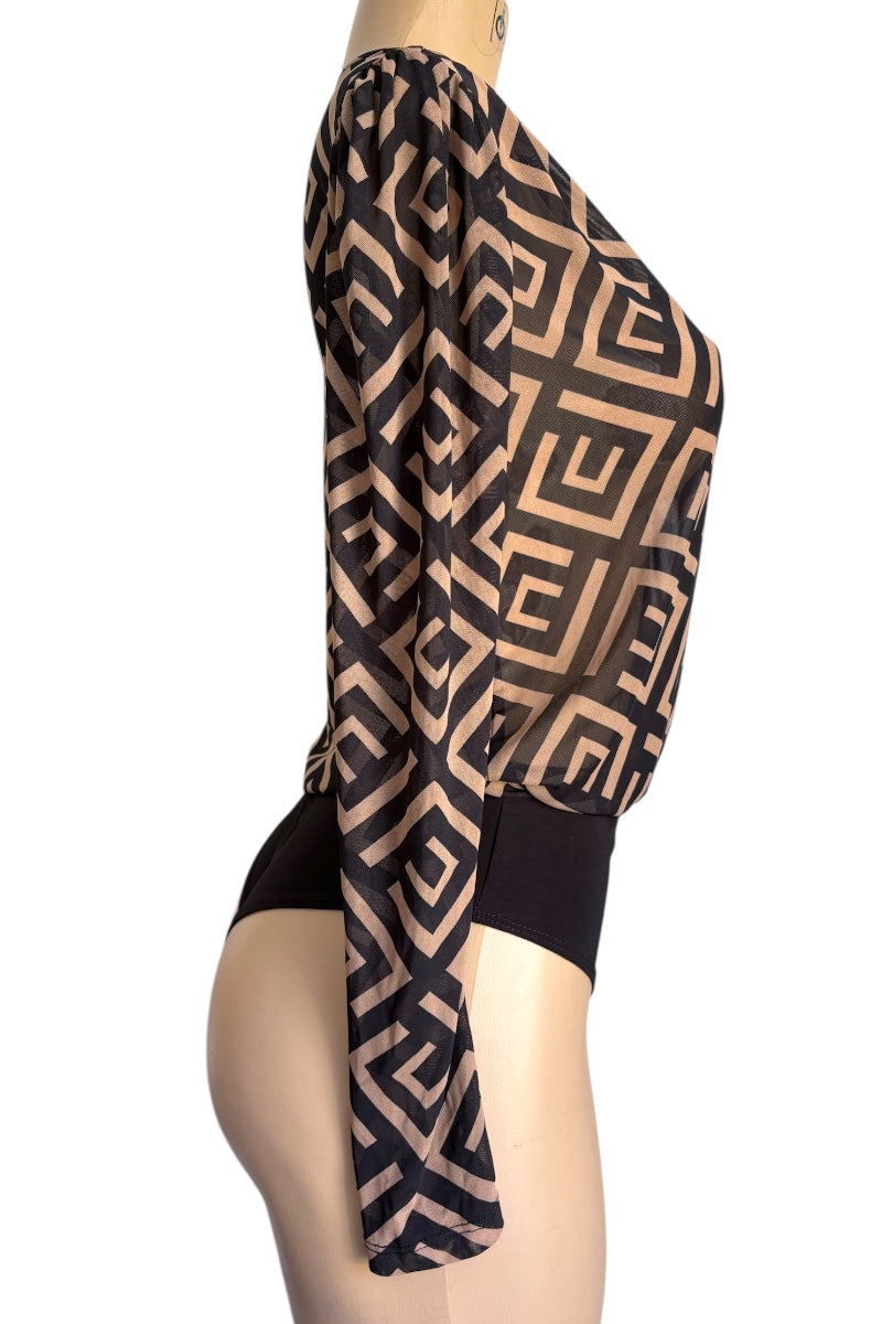 Mannequin wearing a black and beige patterned top with a white background
