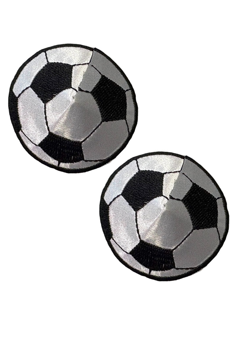Two black and white checkered round soccer ball pasties on a white background