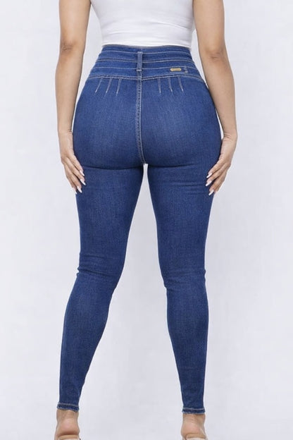 Blue jeans worn by a person on a white background