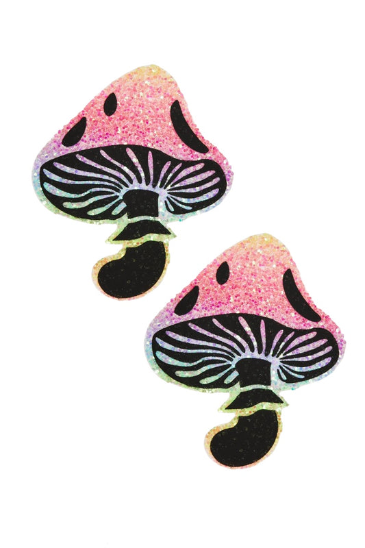 Two pink and black mushroom-shaped pasties on a white background