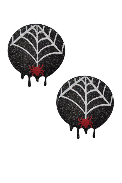 Two black glittery pasties with spider webs and red spiders on a white background