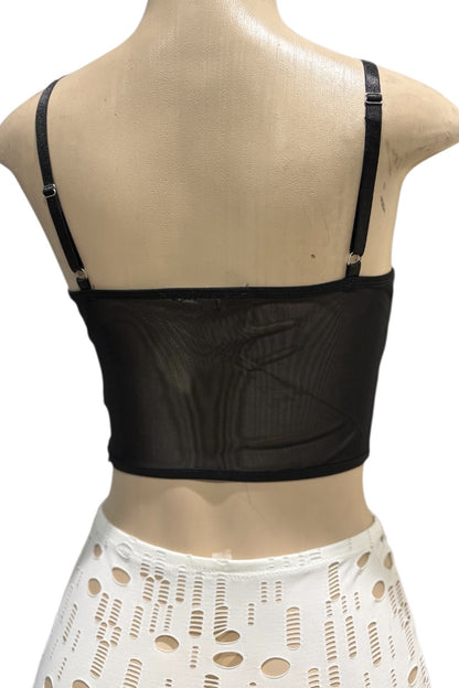 Black crop top on a mannequin with a white background