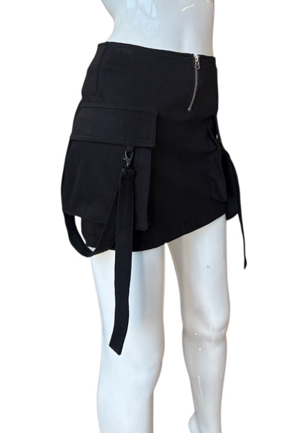 Black skirt with multiple pockets and zippers on a mannequin against a white background