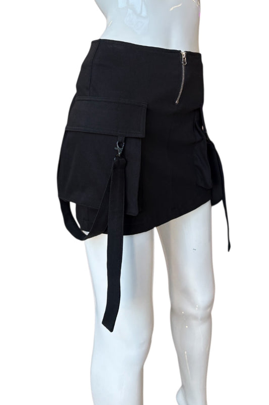 Black skirt with multiple pockets and zippers on a mannequin against a white background