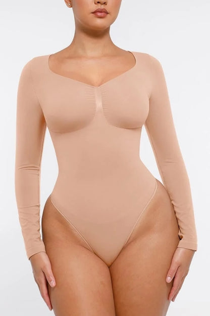 Beige bodysuit worn by a model on a white background