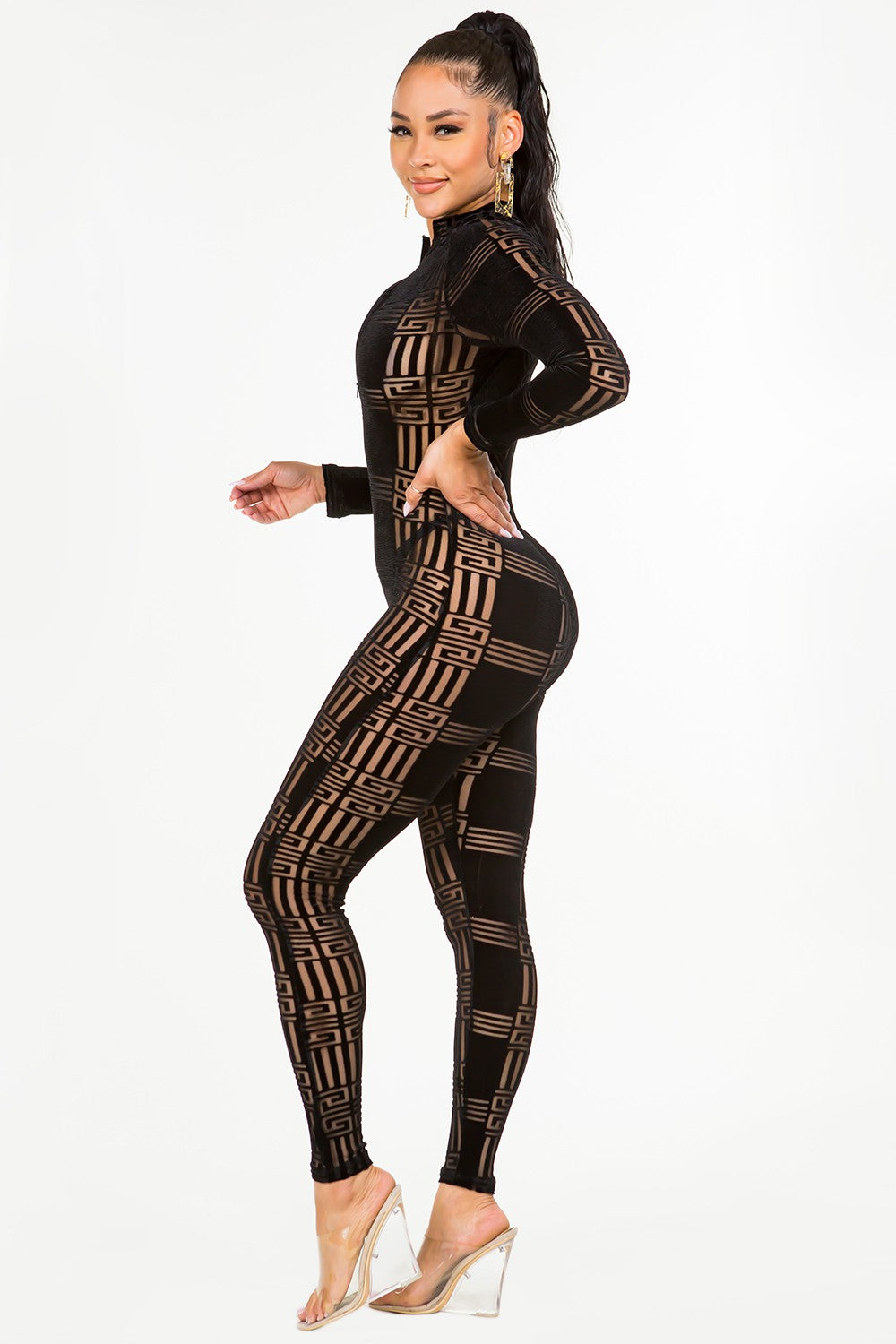 Woman wearing a black velvet jumpsuit on a white background