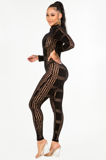 Woman wearing a black velvet jumpsuit on a white background
