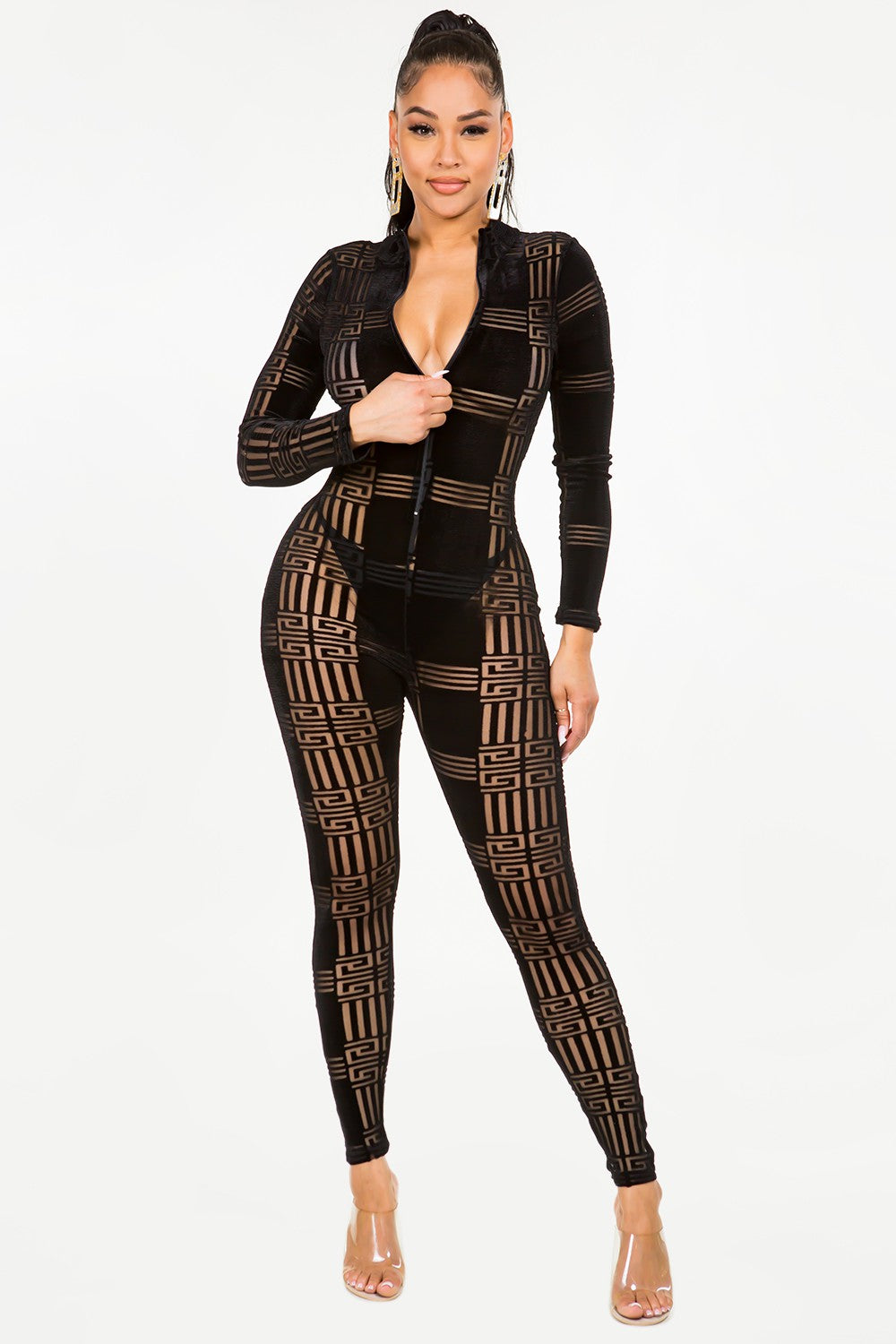 Woman wearing a black velvet patterned jumpsuit on a white background