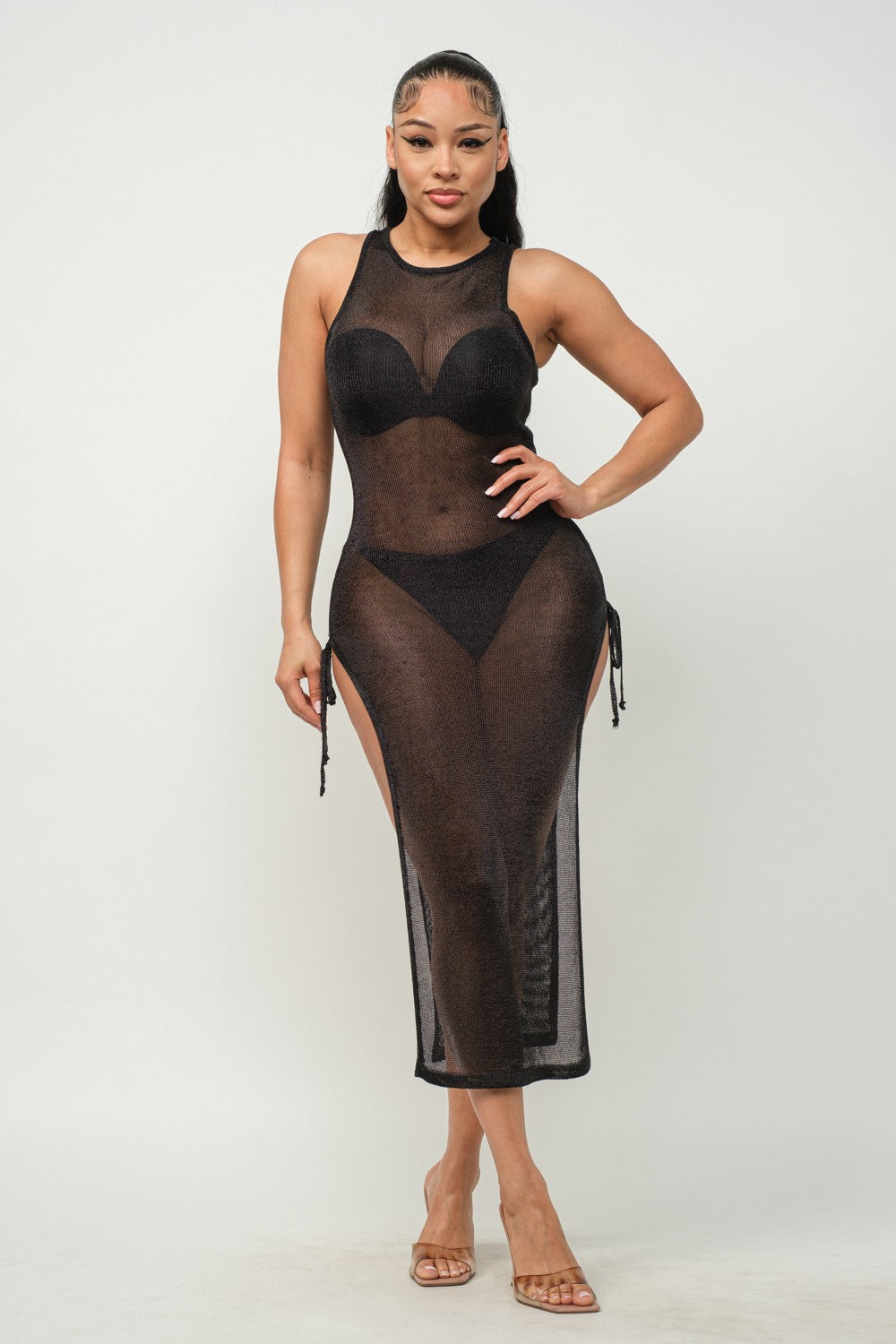 Woman wearing a black sheer dress on a white background