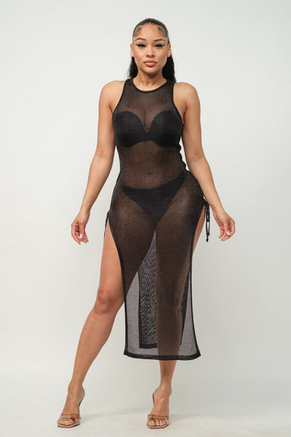 Woman wearing a sheer black dress with a white background