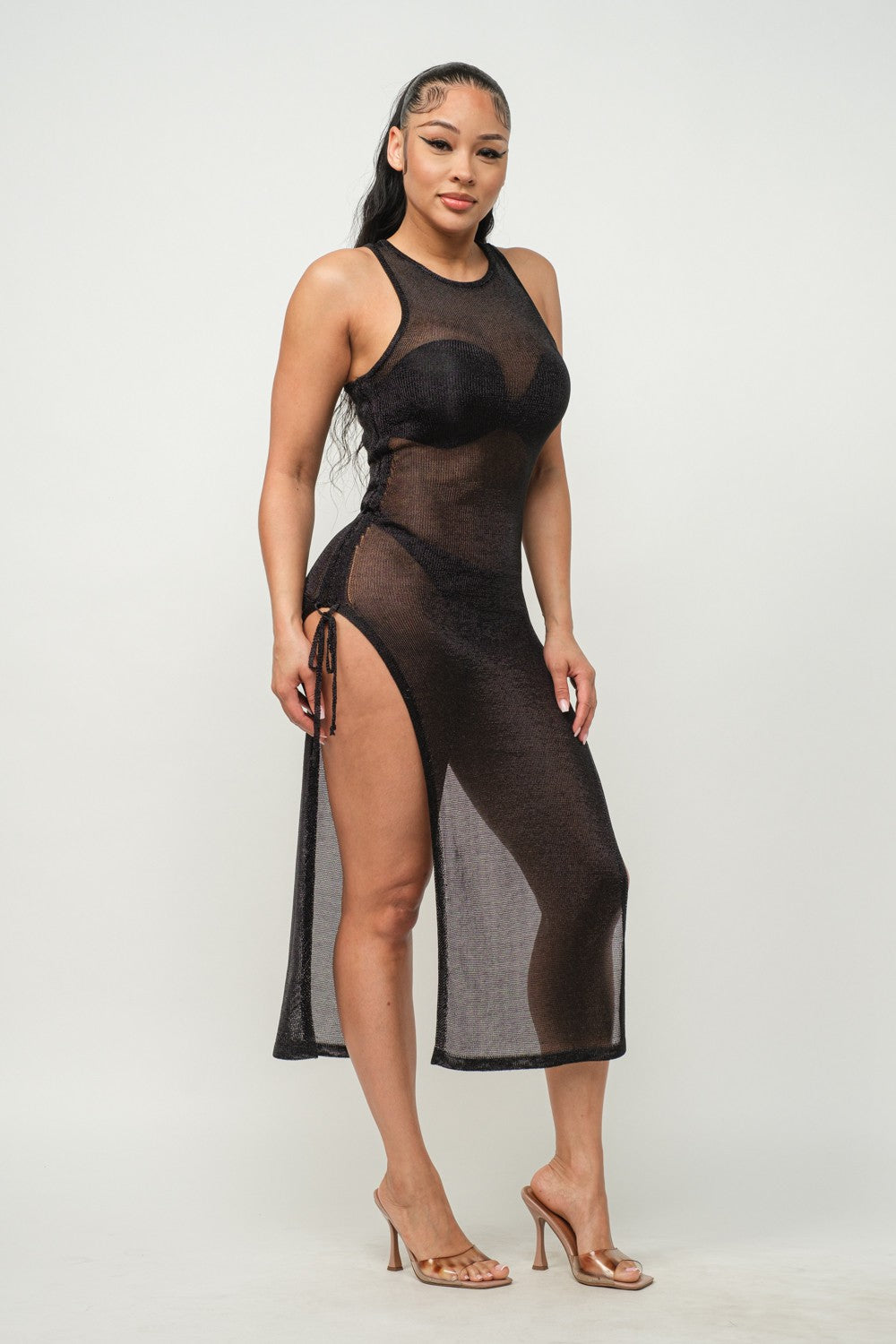 Woman wearing a black sheer dress on a white background