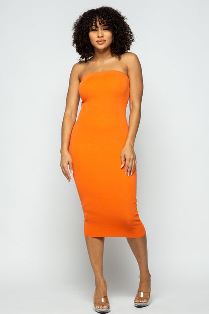 Woman wearing an orange strapless dress against a white background