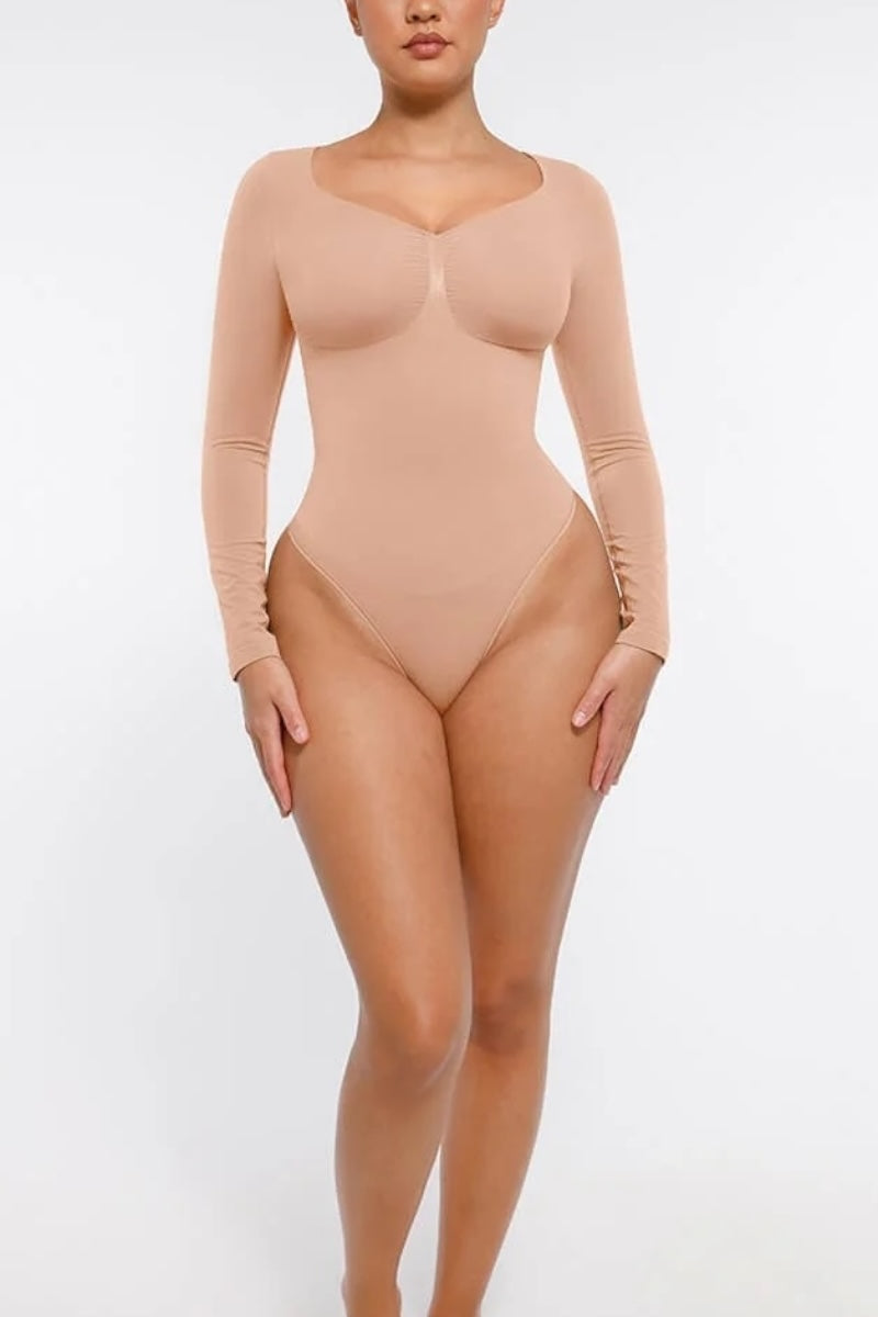 Beige bodysuit worn by a model on a white background