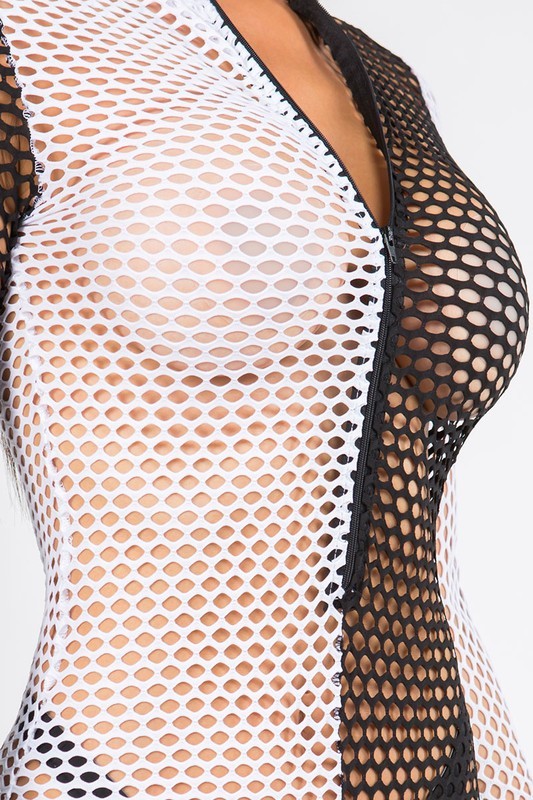 Close-up of a black fishnet bodysuit with a deep V-neckline and open mesh panels over a white undergarment, shown on a model against a light gray background.
