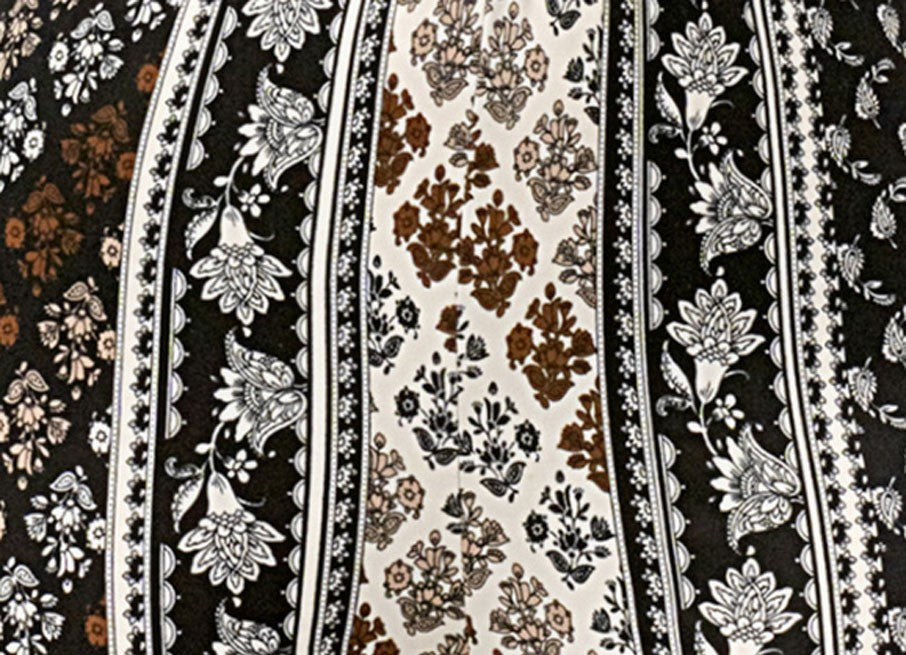 Patterned fabric with floral and stripe designs in black, white, and brown.