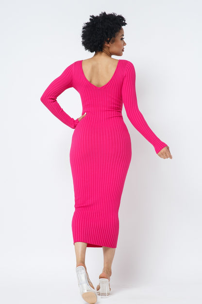 Woman wearing a fuchsia pink ribbed dress against a white background