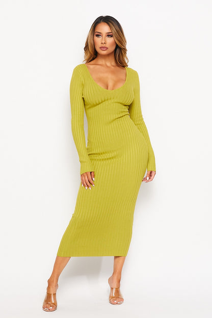 Woman wearing a pistachio green ribbed dress on a white background