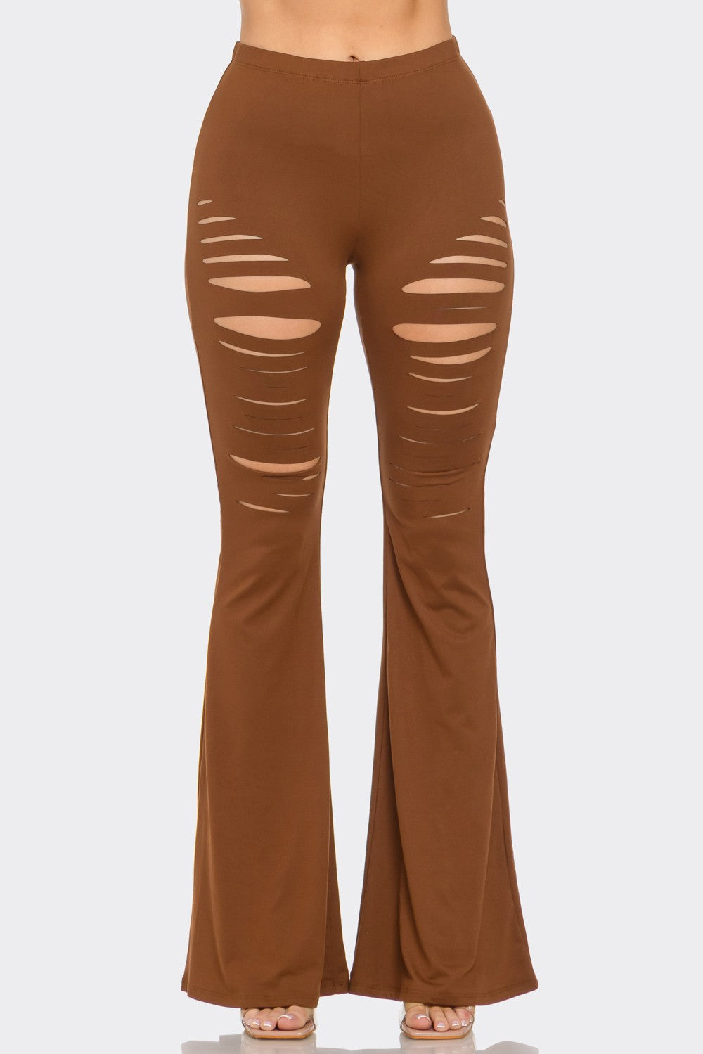 Brown flared pants with distressed details on a beige background