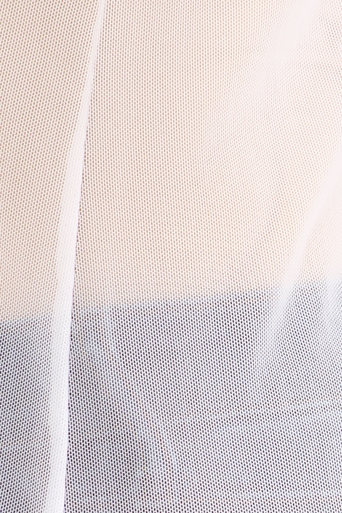 Close-up of a white fabric over a beige and blue outfit. 
