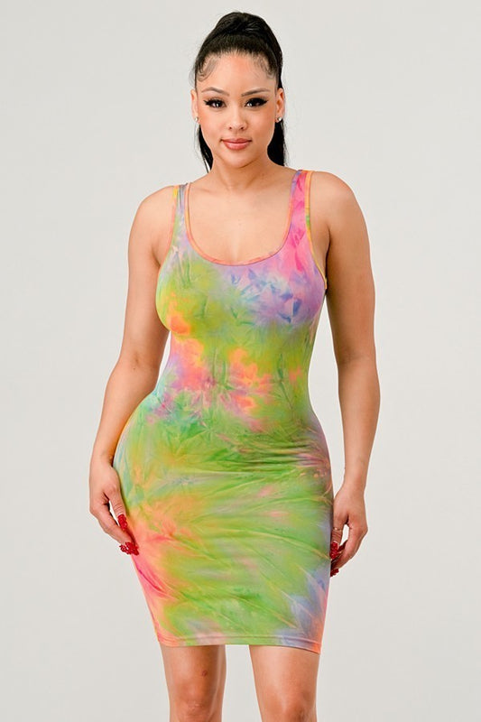 Woman wearing a colorful tie-dye dress on a plain background