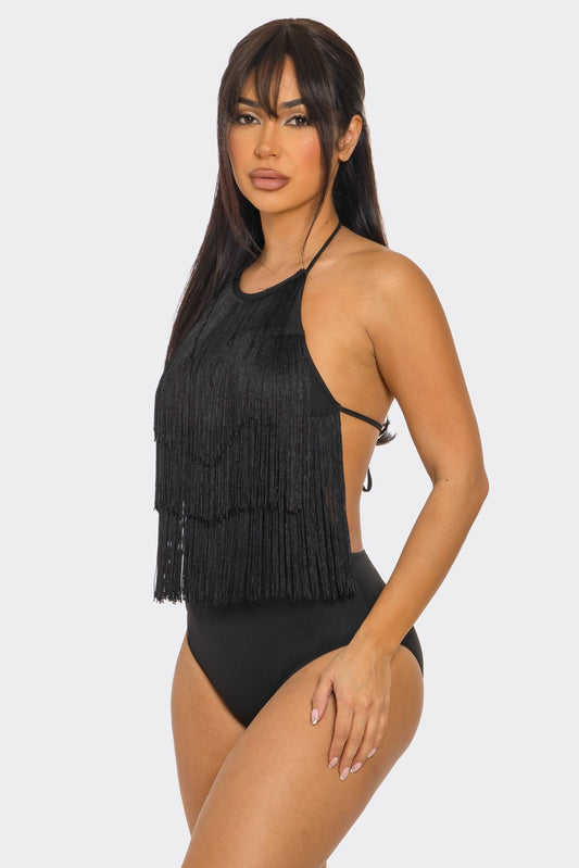 Woman wearing a black fringed bodysuit on a white background