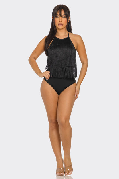 Woman wearing a black fringe bodysuit on a white background