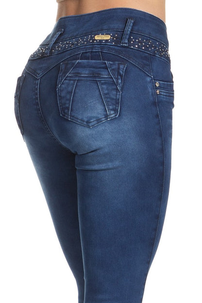 Blue jeans with embellishments on a white background