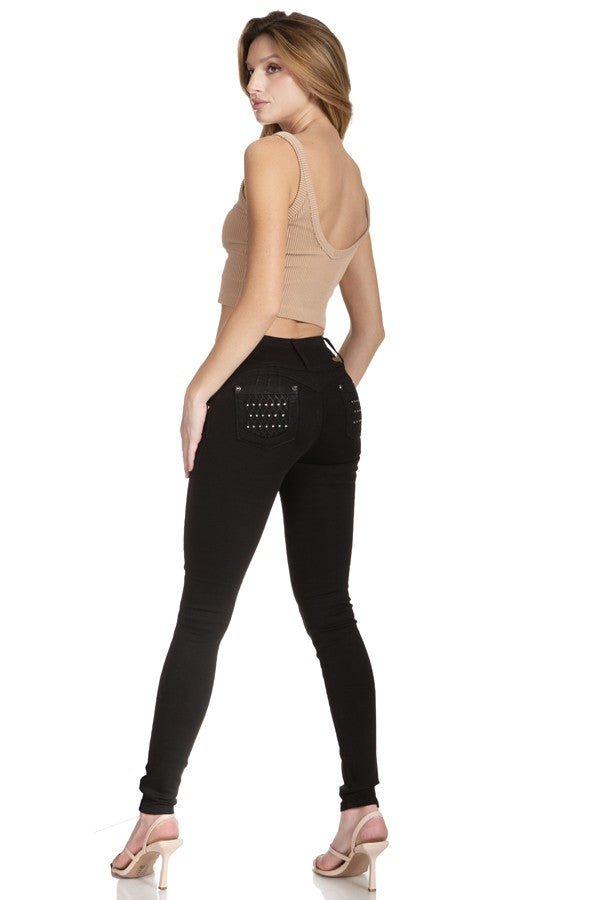 Woman wearing black leggings with embellishments on a white background