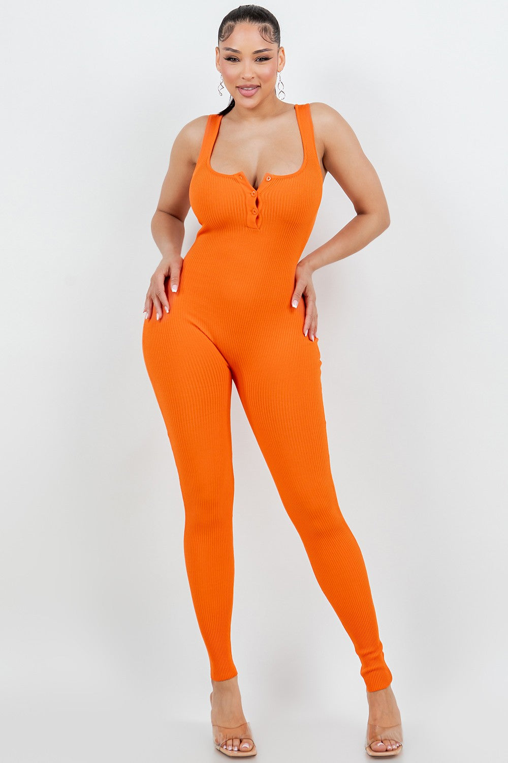 Woman wearing an orange jumpsuit on a white background