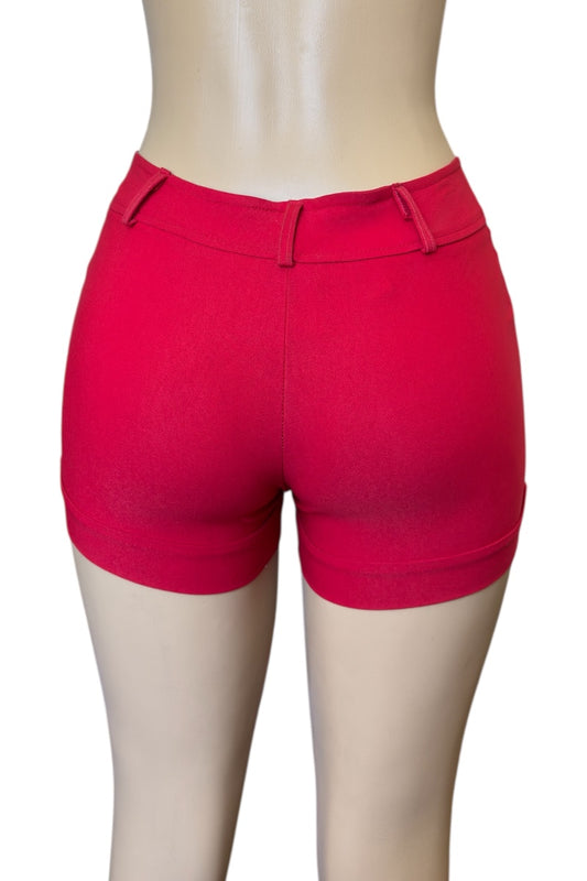 Red shorts on a mannequin against a white background