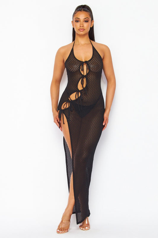 Woman wearing a black mesh dress with cut-out design on a white background