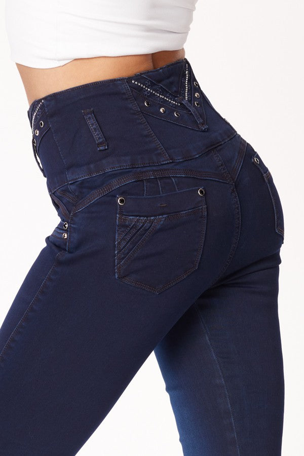 Navy blue jeans with decorative stitching on a white background