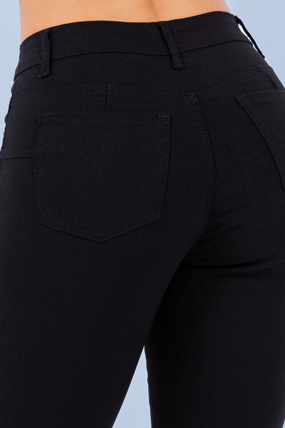 Black pants with a pocket detail on a light blue background