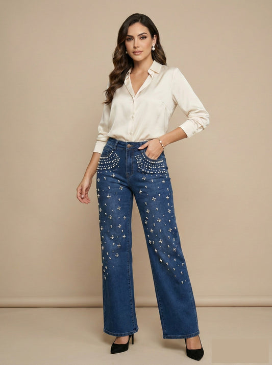 Woman wearing blue jeans with star patterns and a white shirt on a beige background