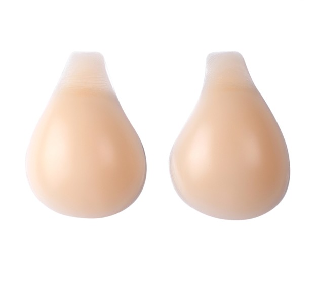 A pair of teardrop-shaped nude silicone adhesive bra on a plain white background.