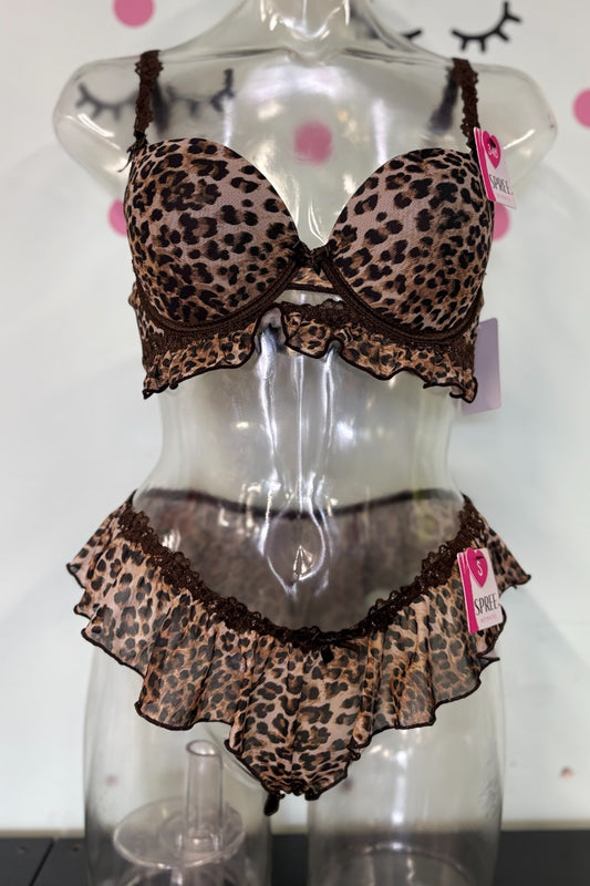 A leopard print lingerie set with ruffle trim displayed on a clear mannequin torso. The set includes a bra and matching high-waisted briefs in a brown and beige animal print pattern with dark brown lace trim.
