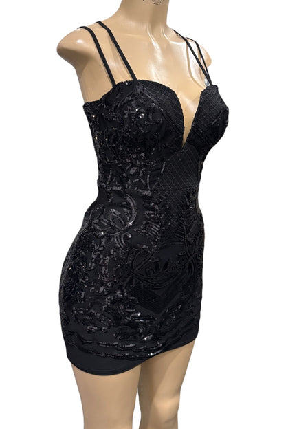 Black sequin dress on a mannequin against a white background