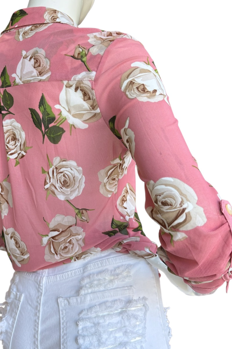 Pink floral blouse on a mannequin with a white background